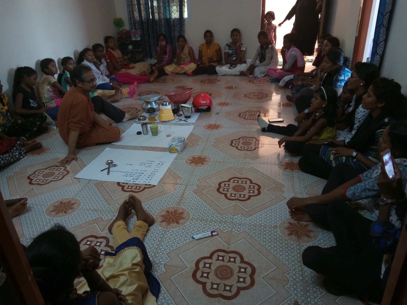 A group session with Chinhari youth members seated in a circle, facilitated in person